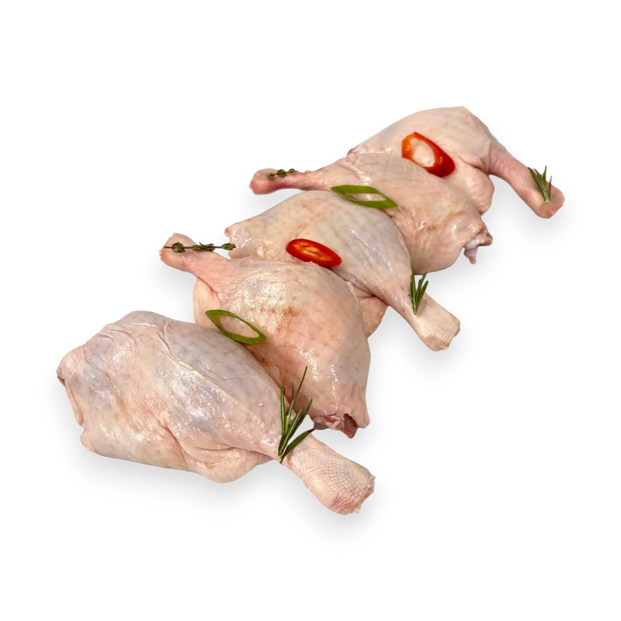Two raw duck legs with red peppers and green herbs