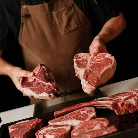 Butcher displaying premium Australian beef steaks from Peter Augustus Craft Butcher