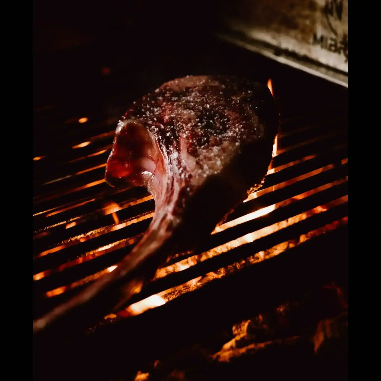Australian tomahawk steak from Peter Augustus grilling over open flames