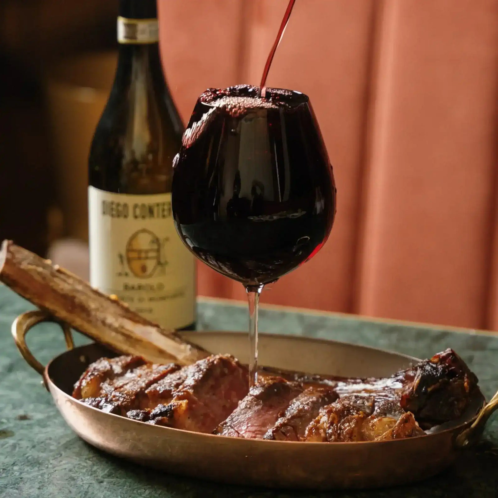 Premium Angus tomahawk steak by Peter Augustus Craft Butcher on wire rack with garnish