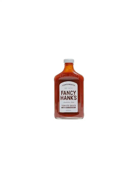 Fancy Hank's tomato sauce in a clear glass bottle with a white label on white background