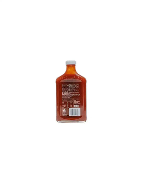 Back of a glass bottle filled with tomato sauce, showing product label and nutrition facts.