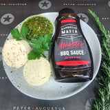 Gourmet condiment pack with BBQ sauce, herb butter, salsa verde, and fresh parsley on a plate
