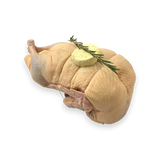 Raw chicken with butter and rosemary on a white background