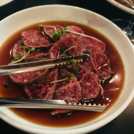 Marbled Australian Wagyu beef slices in broth with microgreens, Peter Augustus Craft Butcher
