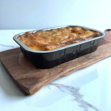 Golden baked beef lasagna in a black tray from Peter Augustus Craft Butcher