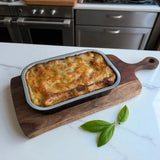 Baked beef lasagna in tray on wooden board, Peter Augustus gourmet ready meal