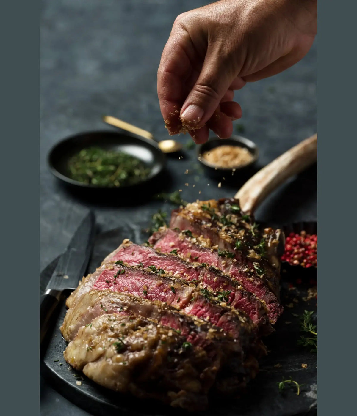 Sliced Wagyu tomahawk steak with herbs and seasoning, the centrepiece cut in the Father's Day hamper