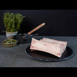Australian beef marrow bones on slate plate with fresh herbs, Peter Augustus Craft Butcher