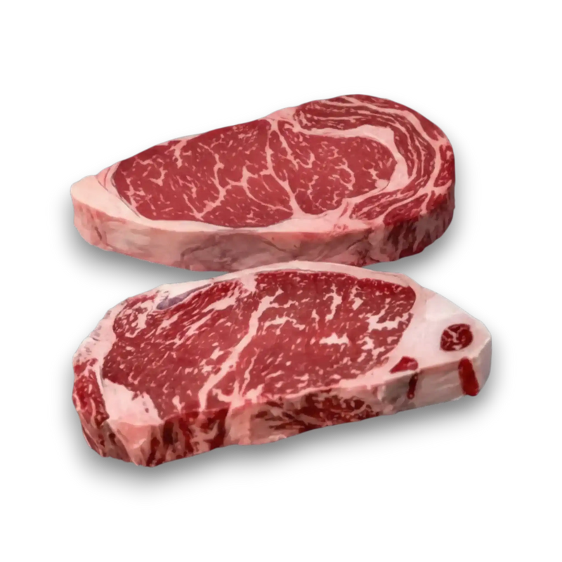 Two premium marbled beef steaks, rich red with white fat, showcasing high-quality Wagyu or Angus cut.