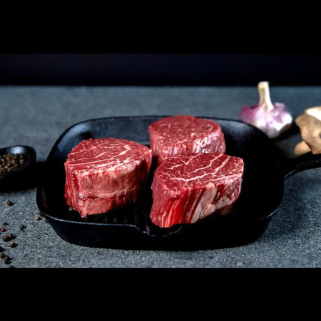 Peter Augustus Wagyu eye fillet steaks with rich marbling in cast iron pan, premium Australian beef