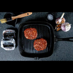 Wagyu beef eye fillet steaks on grill pan with garlic, salt, and Peter Augustus packaging
