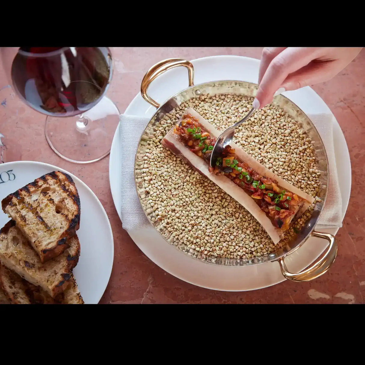 Roasted bone marrow with herbs and toasted bread, gourmet beef dish from Peter Augustus