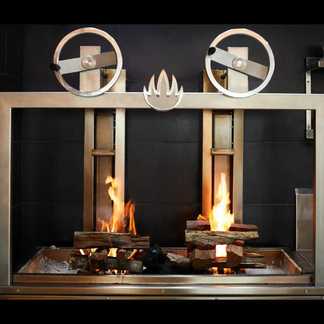 Modern stainless steel wood-fired grill with burning logs at Peter Augustus Craft Butcher