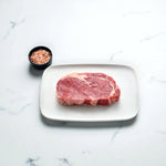 Angus rib fillet steak on a white plate with Himalayan pink salt, Peter Augustus beef