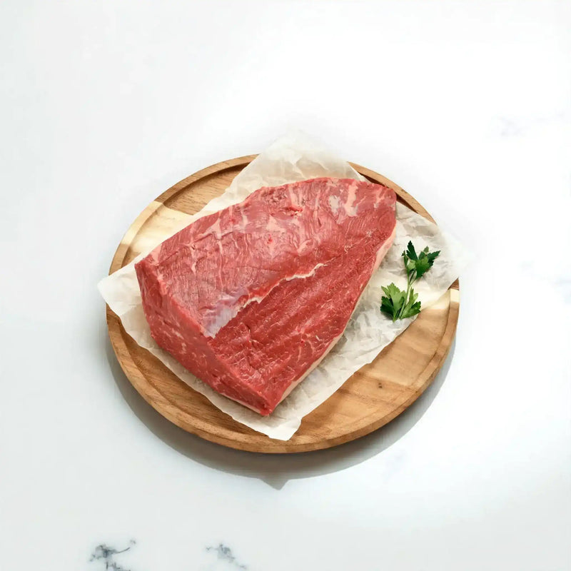 Raw Angus beef rump cap steak on a wooden board with parsley, Peter Augustus Craft Butcher