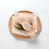 Peter Augustus free range whole chicken on baking paper with fresh thyme, craft butcher quality