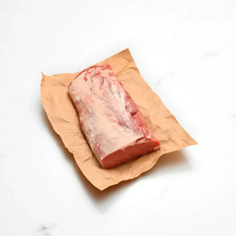 raw grain-fed rib fillet beef whole cut on butcher paper, white background