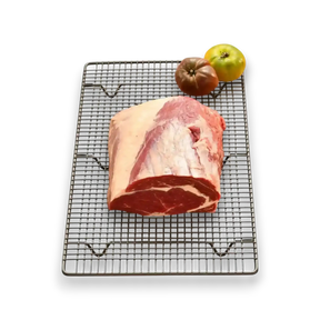 Fresh grass-fed beef roast on cooling rack with heirloom tomatoes, premium Australian butcher quality