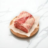 Premium Australian Wagyu rib fillet piece from Peter Augustus on parchment and wooden plate