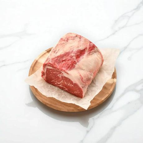 Premium Australian Wagyu rib fillet piece from Peter Augustus on parchment and wooden plate