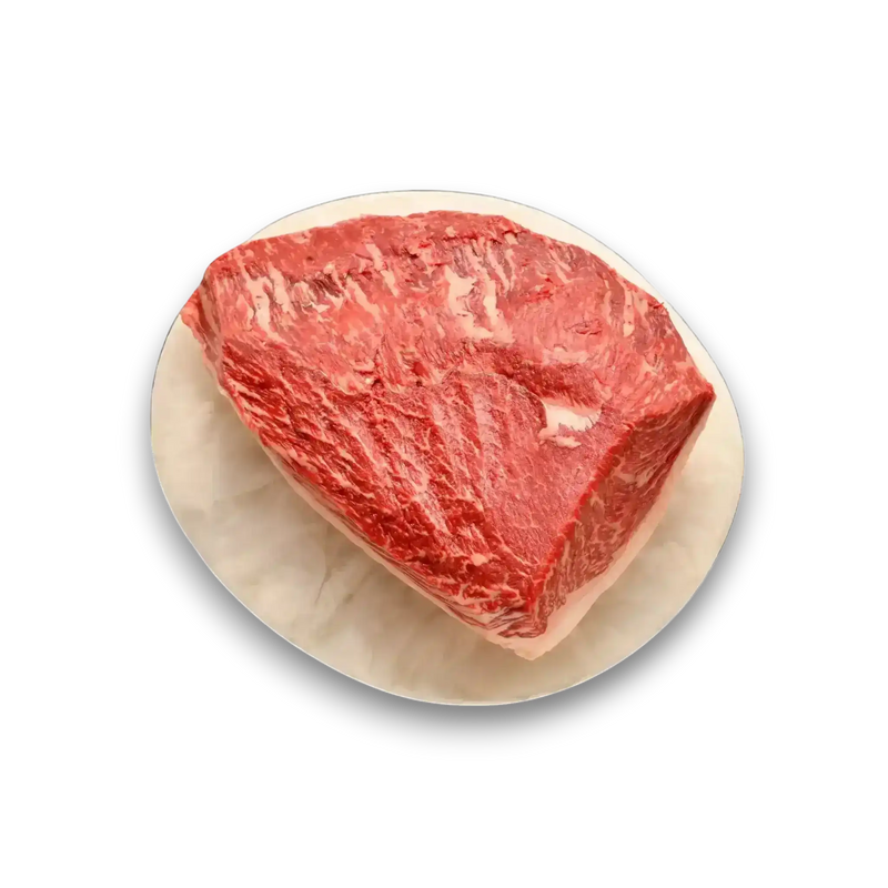Freshly butchered marbled beef roast on marble platter, premium grass-fed Australian beef