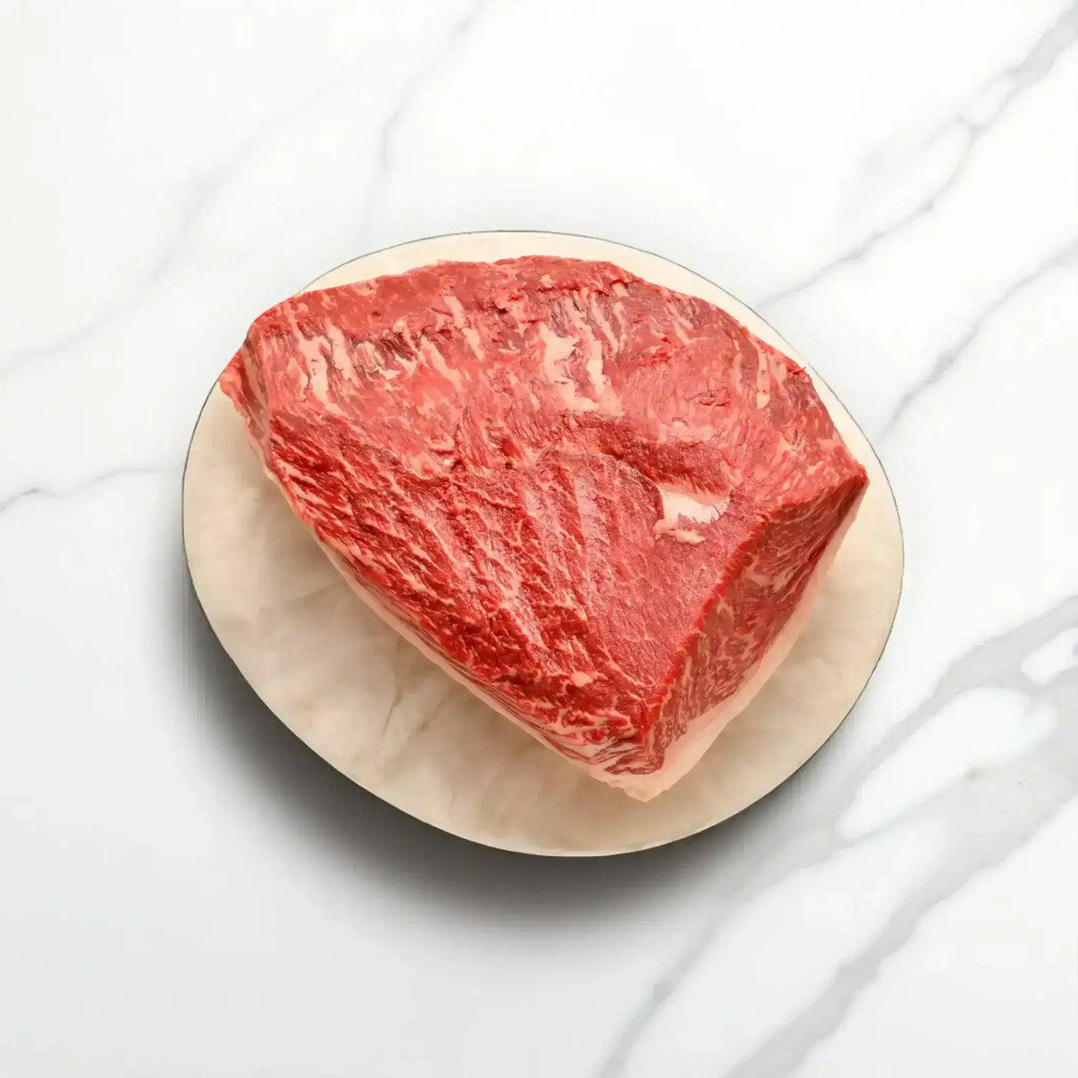 Australian Wagyu rump cap steak with rich marbling on a plate from Peter Augustus Craft Butcher