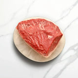 Australian Wagyu rump cap steak with rich marbling on a plate from Peter Augustus Craft Butcher