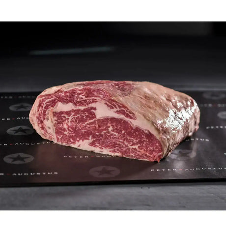 Premium marbled Australian beef cut from Peter Augustus Craft Butcher, displayed on branded paper.
