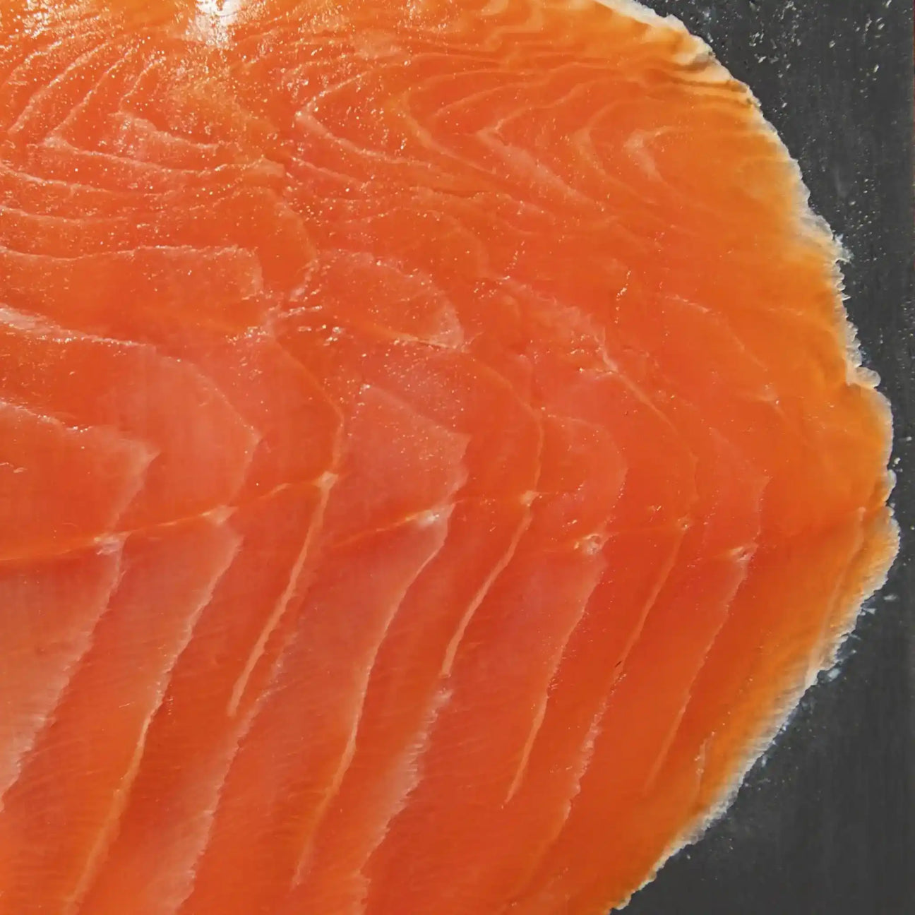 Close-up of fresh sliced salmon fillet with vibrant orange color and delicate marbling