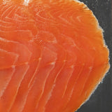 Close-up of fresh sliced salmon fillet with vibrant orange color and delicate marbling