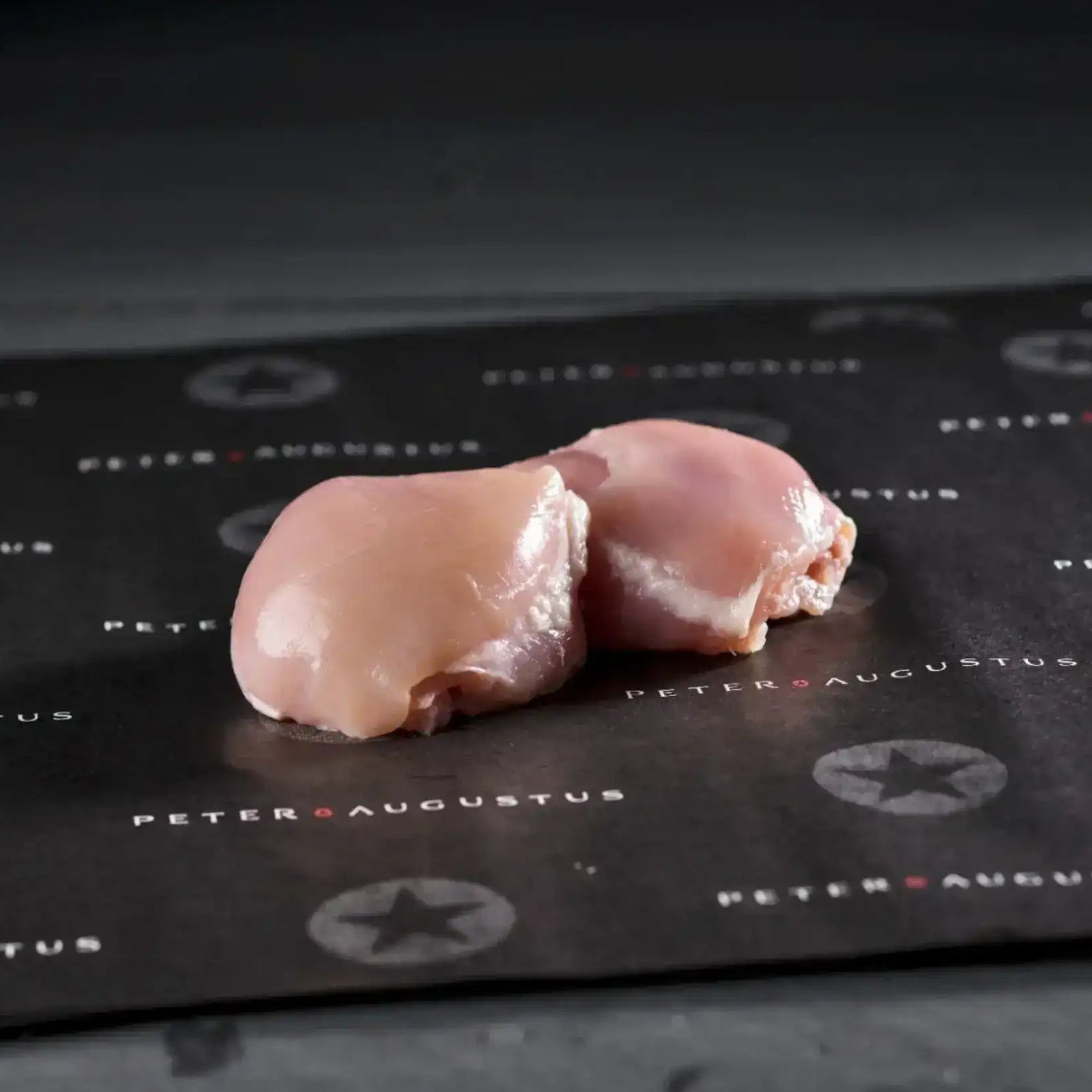 Peter Augustus free-range chicken thigh fillets skin off on platter with parsley garnish