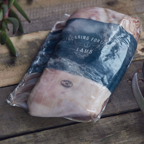 Packaged lamb on a wooden surface with 'Roaring Forties Lamb' branding.