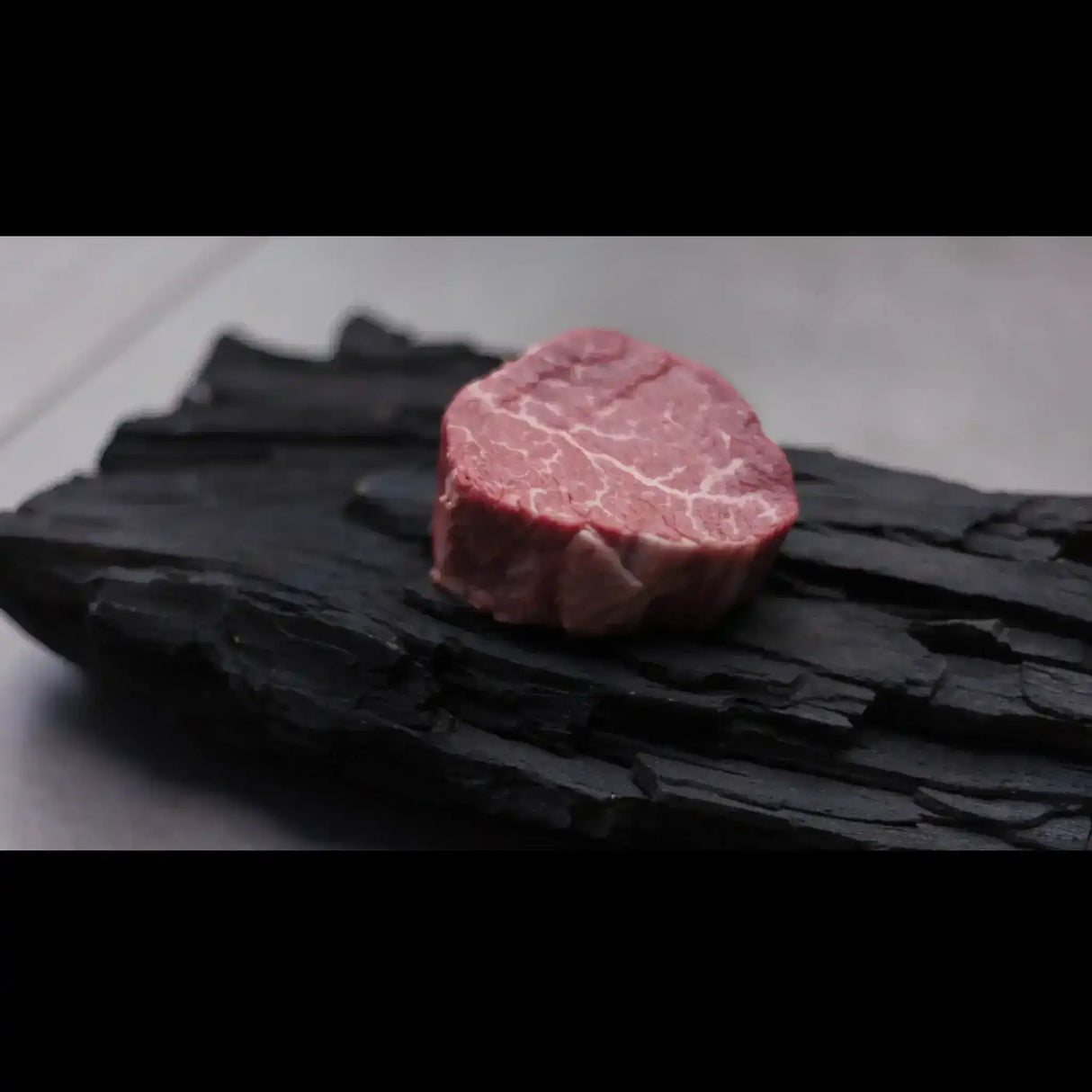 Premium marbled Australian Wagyu beef steak from Peter Augustus Craft Butcher on charcoal