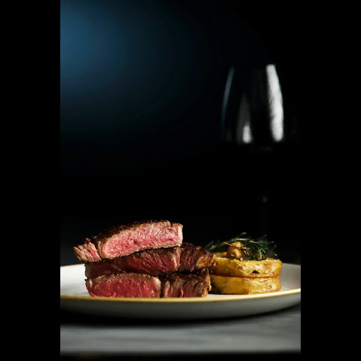Medium-rare Australian beef steak with potatoes on plate, Peter Augustus premium selection