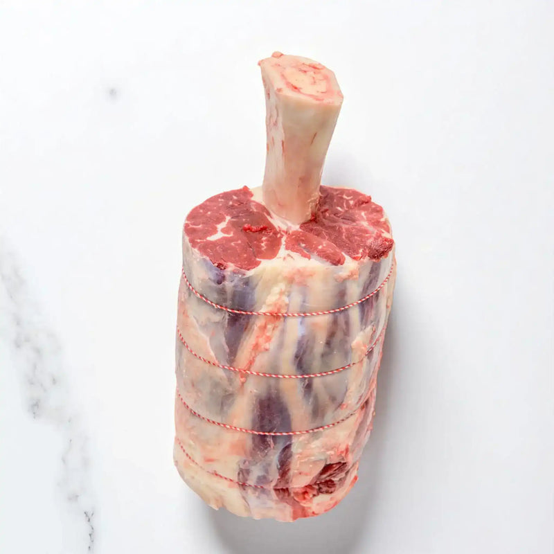 Raw bone-in beef roast tied with butcher twine, Peter Augustus Australian beef