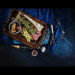 Premium Australian beef steak sliced on a tray with roasted potatoes and yellow beans