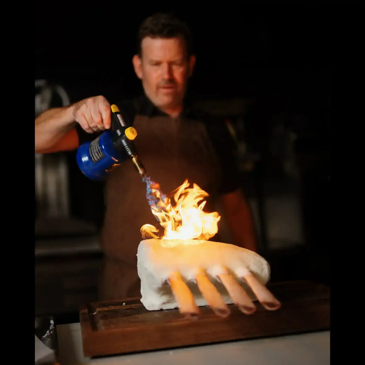 Butcher torching a tallow dipped Wagyu Tomahawk rack, Peter Augustus premium Australian beef