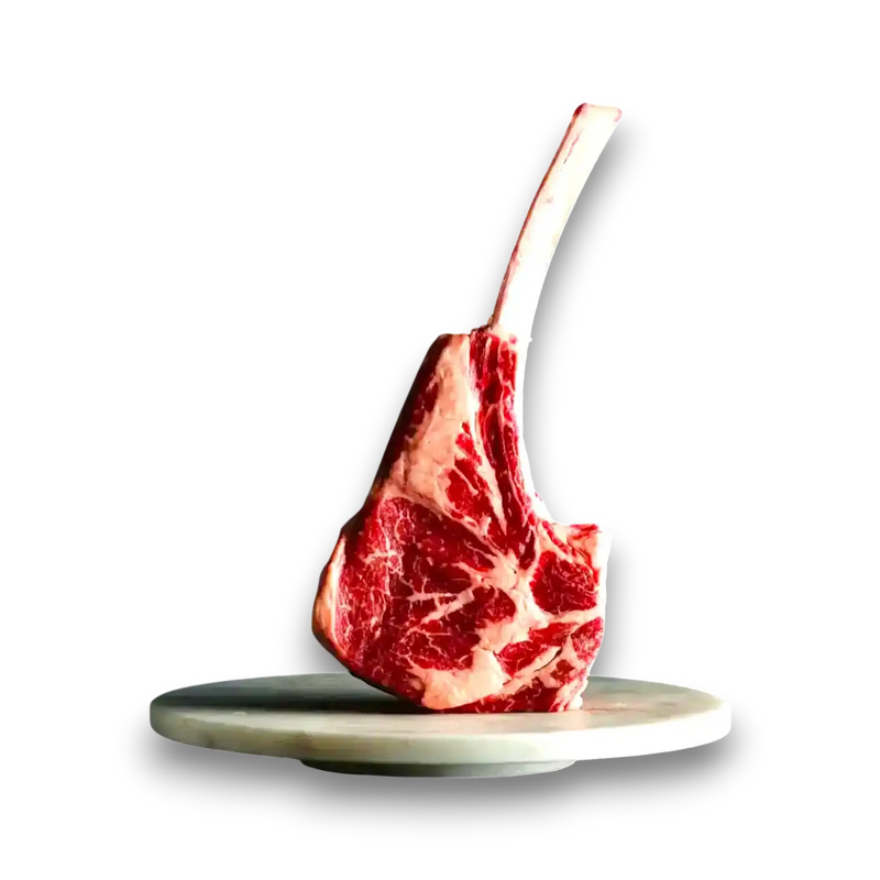 Premium Wagyu tomahawk steak with rich marbling, presented on marble platter