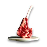Premium Wagyu tomahawk steak with rich marbling, presented on marble platter