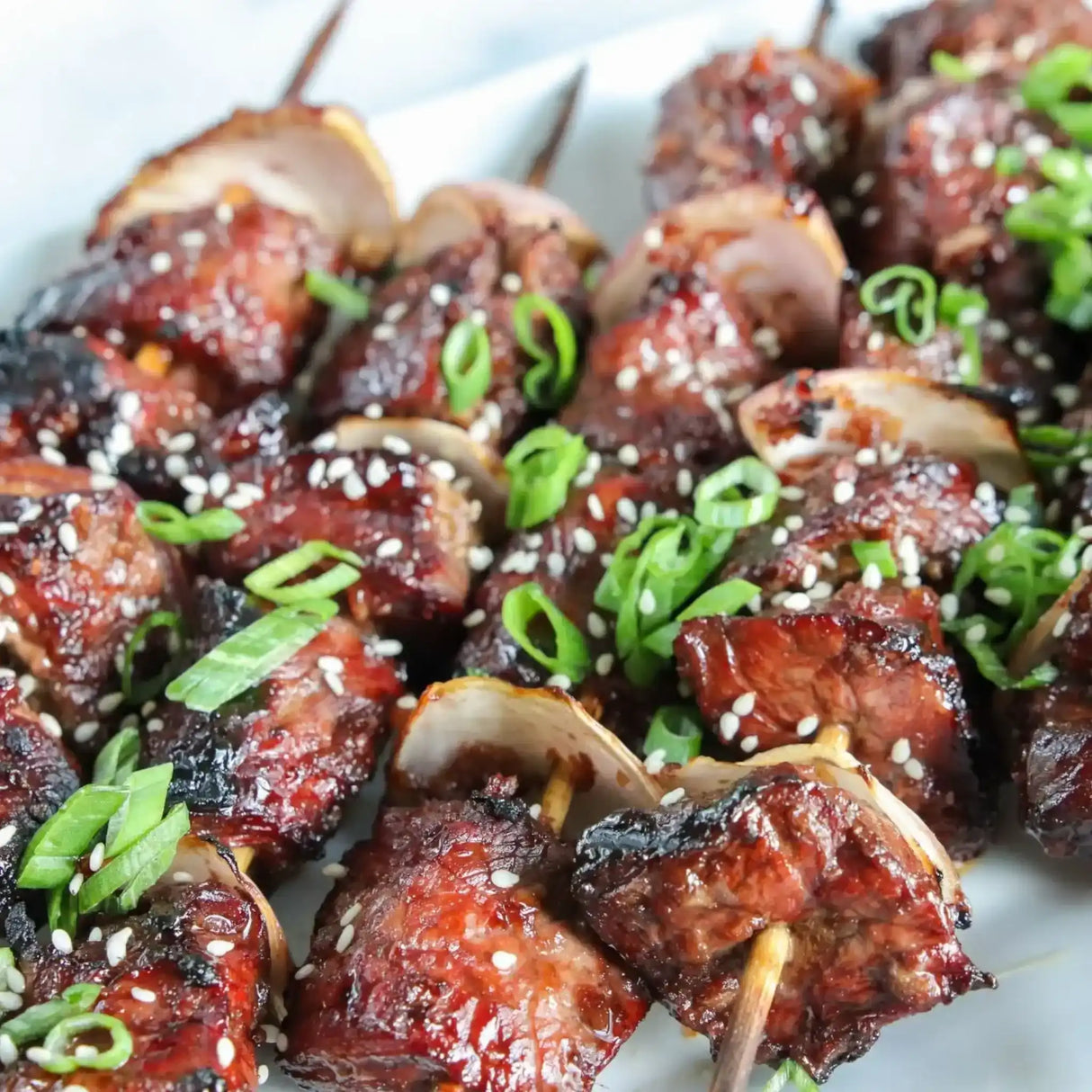 Yakitori beef kebabs topped with sesame seeds and green onions, featuring premium Australian beef.